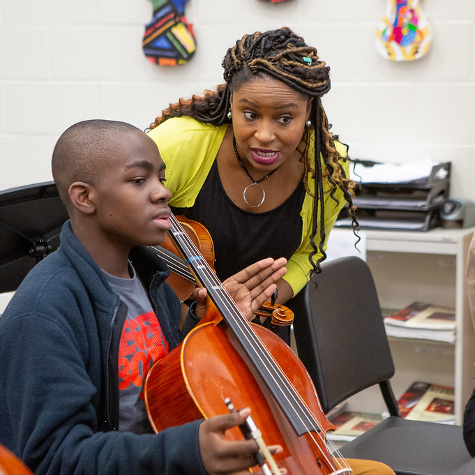 Picture of a cello student and teacher